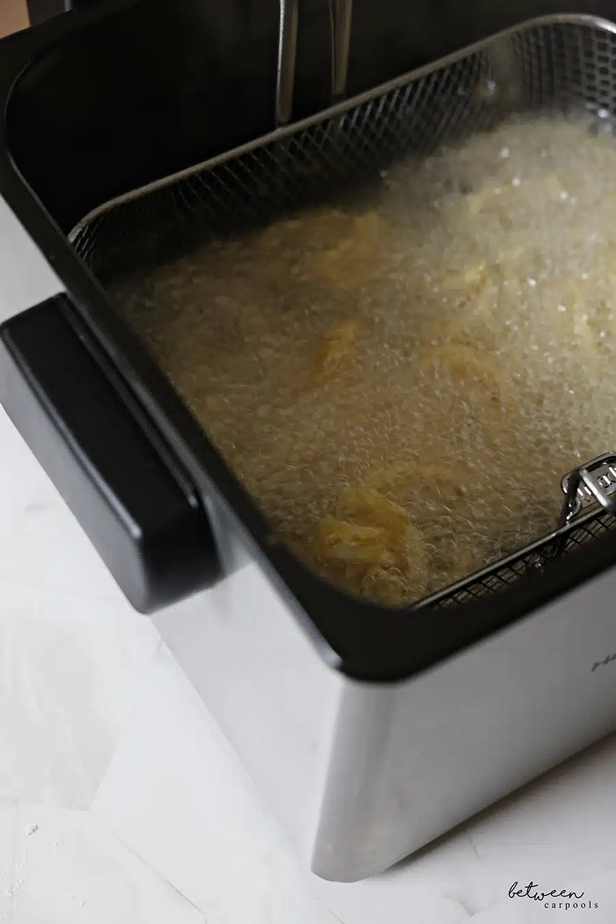 Deep frying onion strings in a Hamilton Beach electric deep fryer.