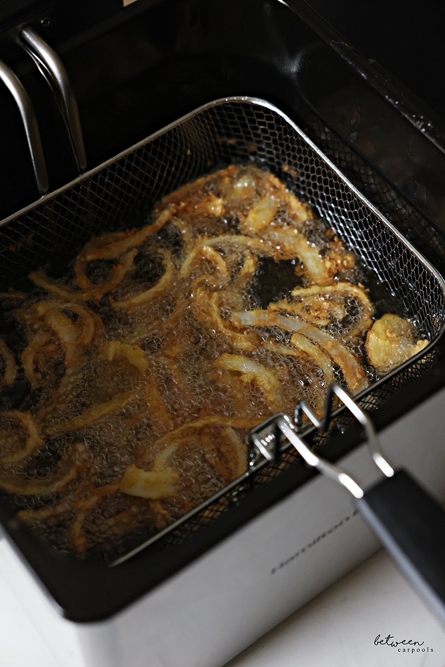 Deep frying onion strings in a Hamilton Beach electric deep fryer.