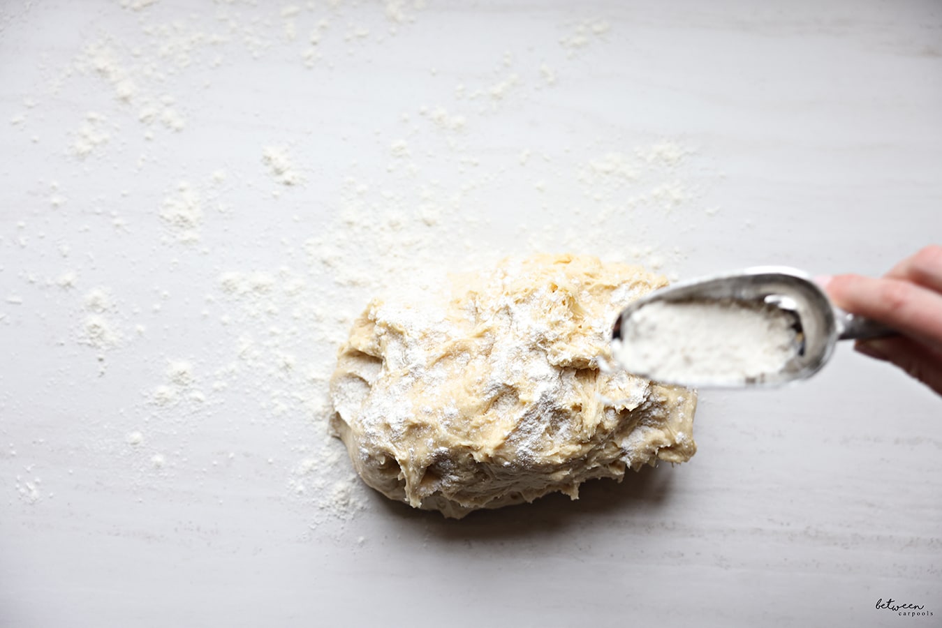 Sprinkling additional flour on the dough on the floured counter.