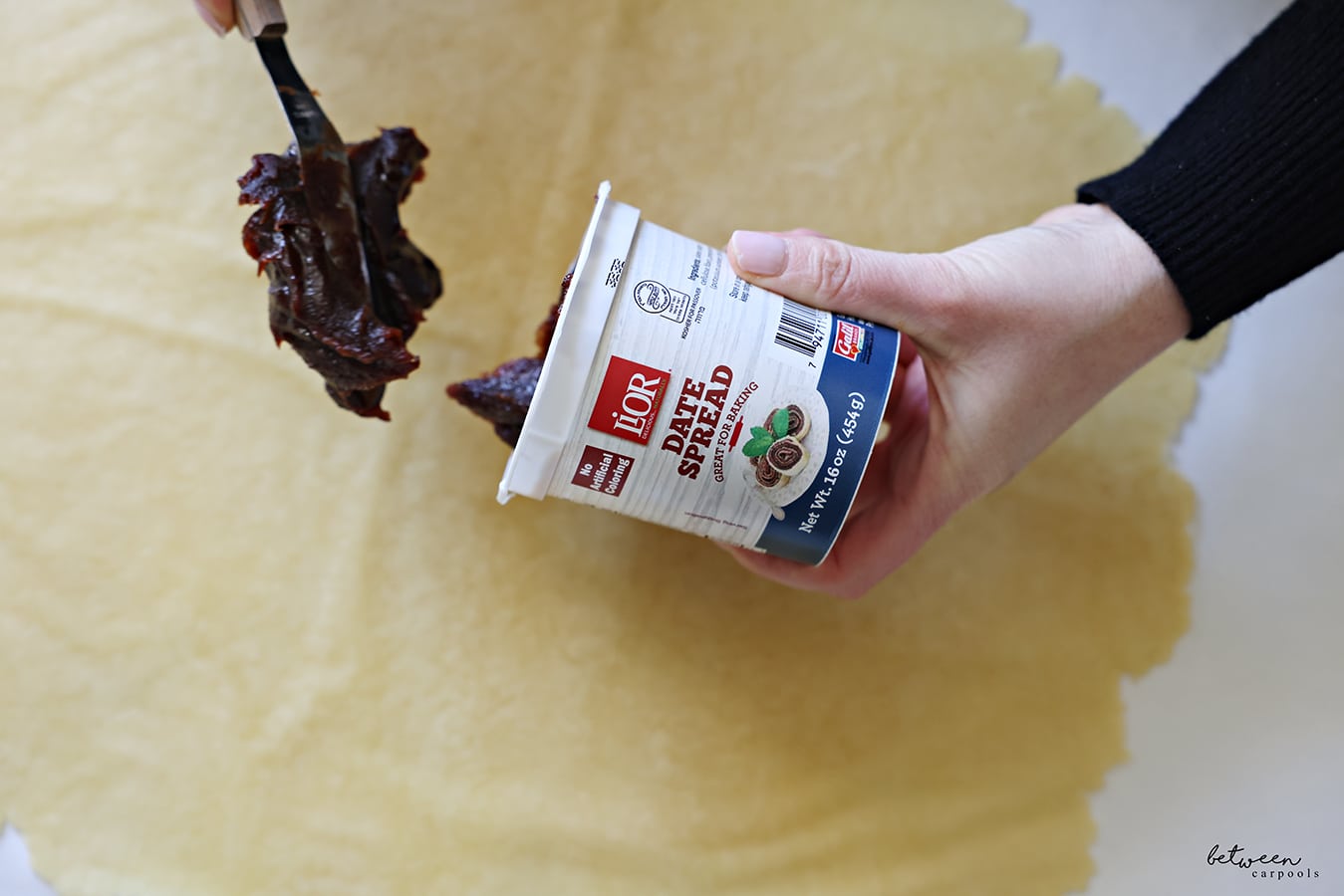 Adding date spread to one half of dough rolled flat into a large rectangle.