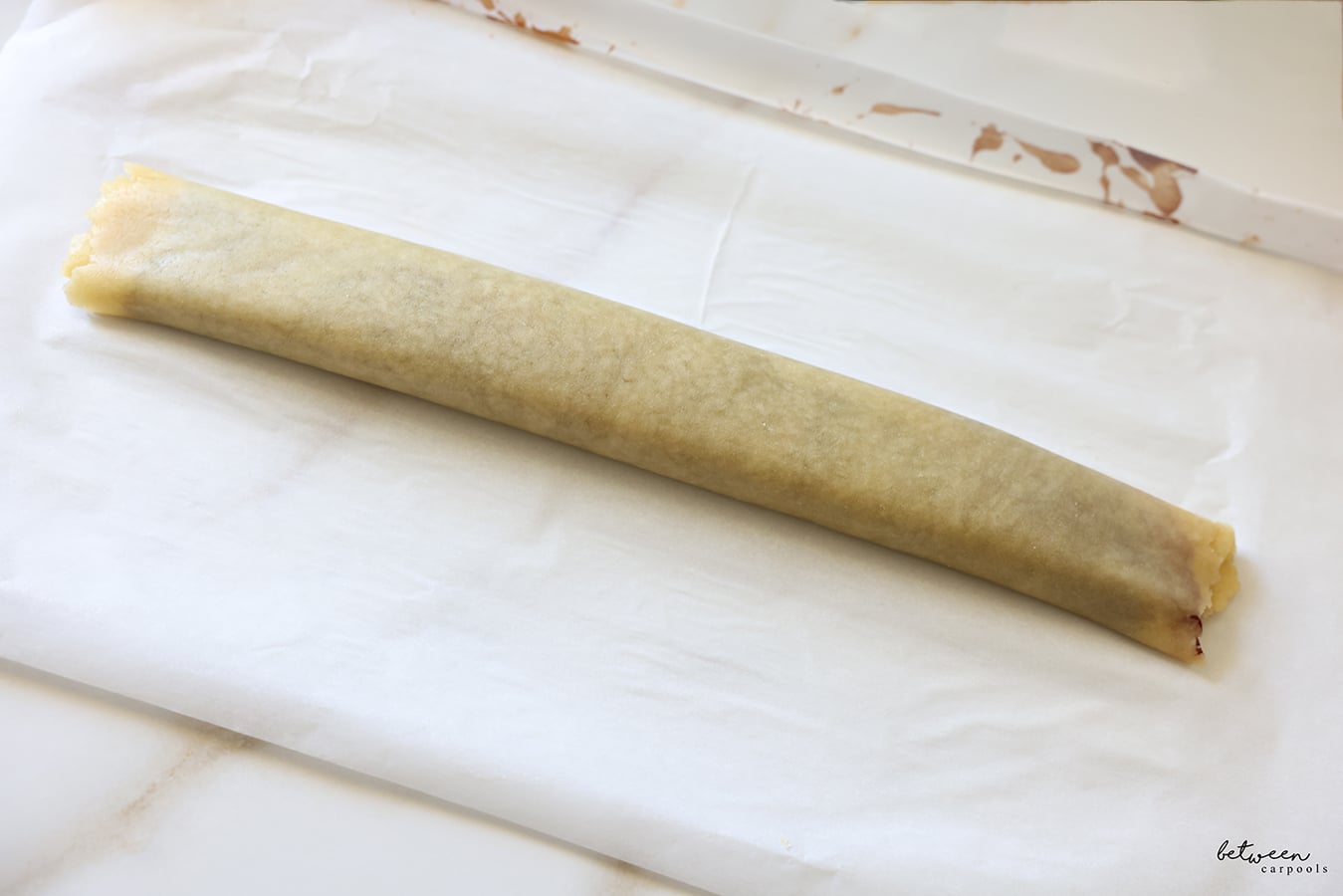 Rolled dough jelly-roll style on a parchment lined baking sheet.