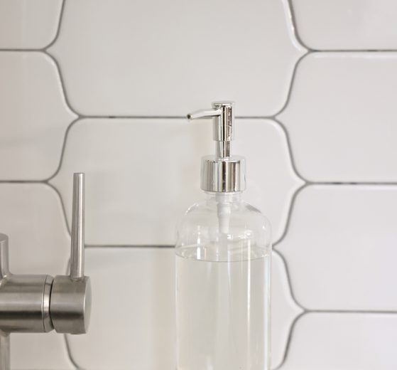 Palmolive Ultra Pure + Clear Liquid Dish Soap Detergent - Fragrance Free in a Clear Soap Dispenser near a kitchen sink.