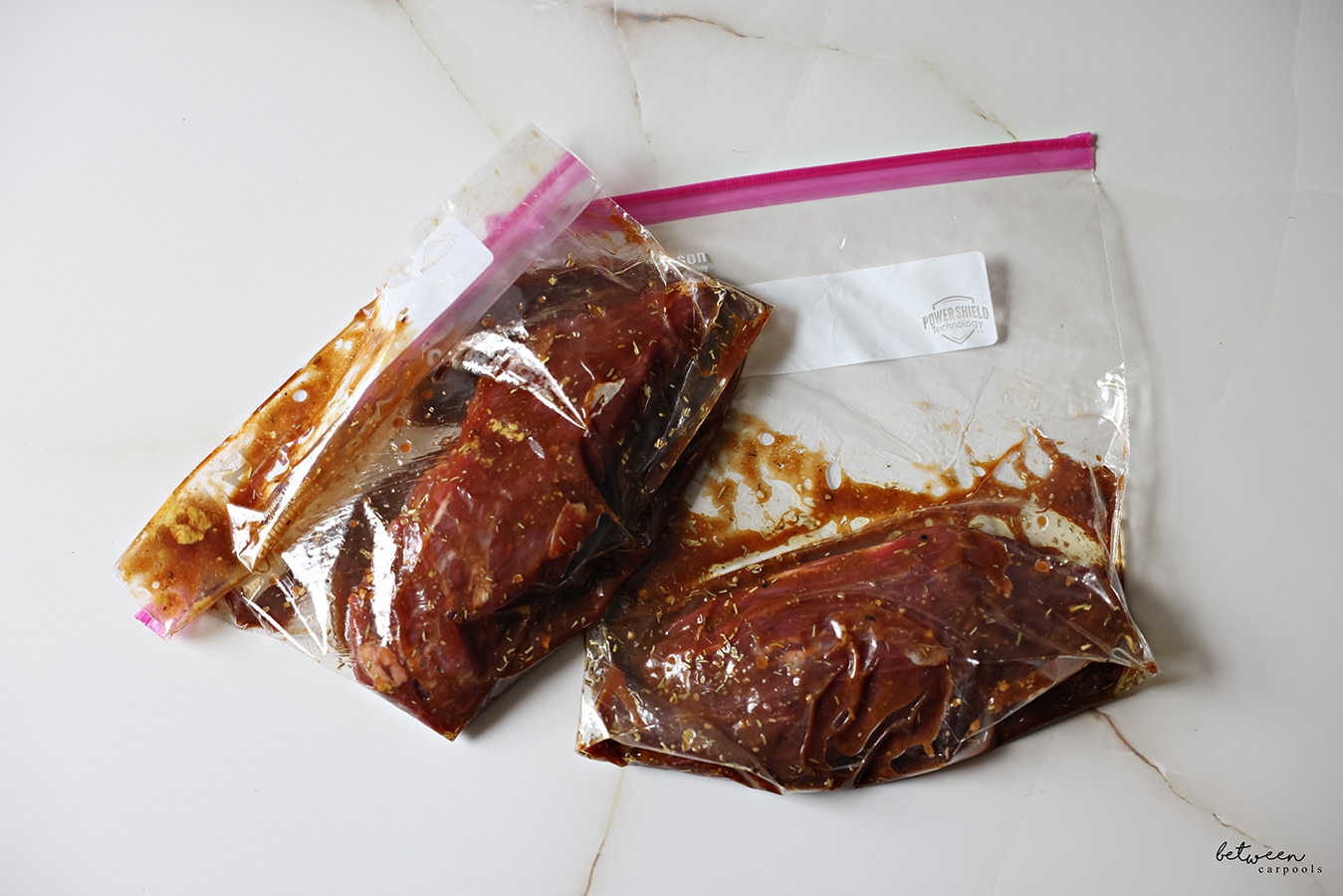 2 sealed Ziploc bags, each with an oyster steak and marinade.