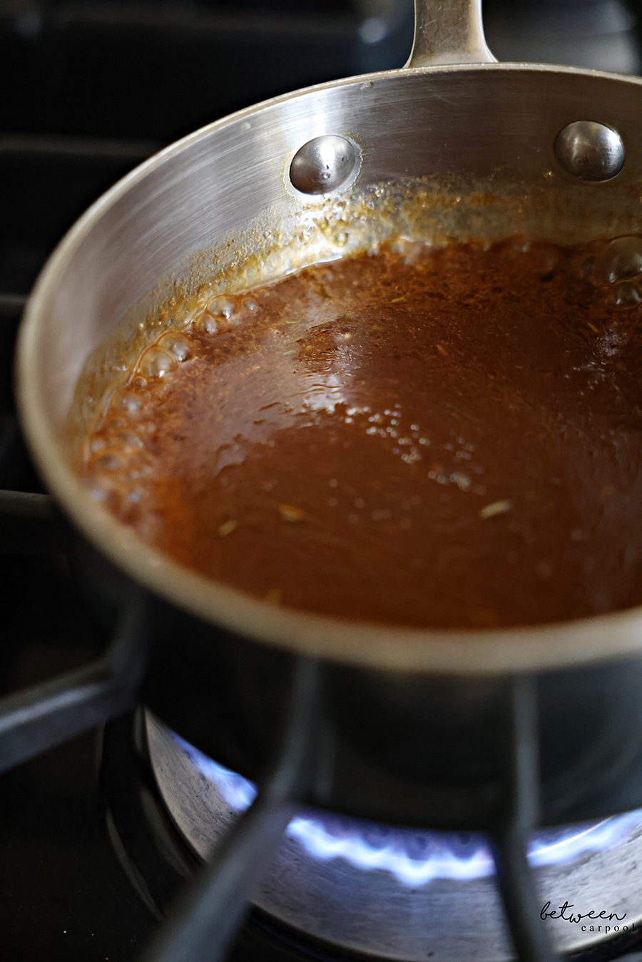 Bringing the marinade in a pot to a boil over a flame.