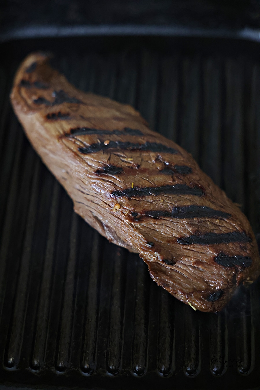 Searing a sous vide oyster steak on a grill pan.