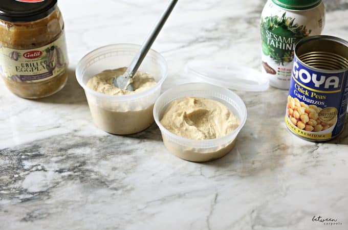 Galil grilled eggplant, 16 oz plastic deli container with Chummus Ganush, 8 oz container with chummus, sesame tahini and an empty can of Goya chick peas.