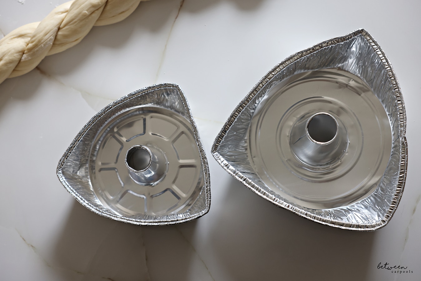 The sides of an 8" and 10" aluminum foil tube pan bent in to resemble triangles.