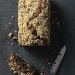 Meltaway Babka on dark background with one cut slice and a Cutco knife. From Rivky Kleiman's Simply Pesach and Beyond cookbook.