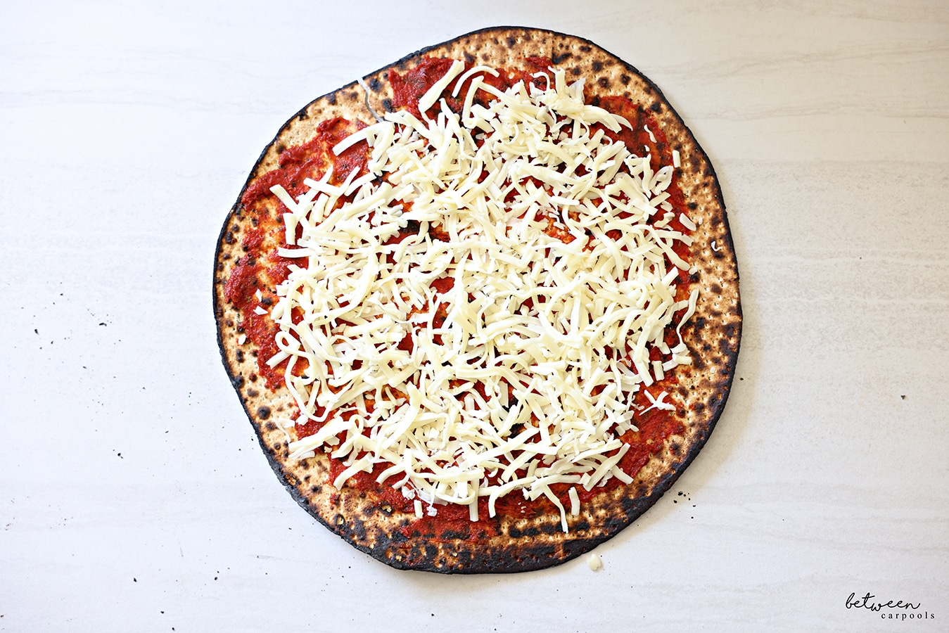 One round Shmurah Matzah with a thin layer of seasoned tomato paste and cheese.