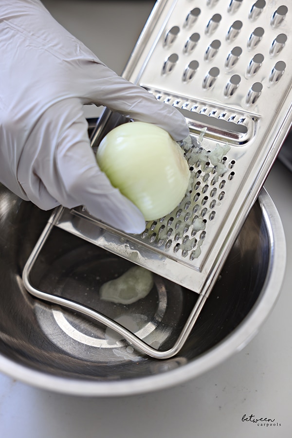 Grating an onion by hand.