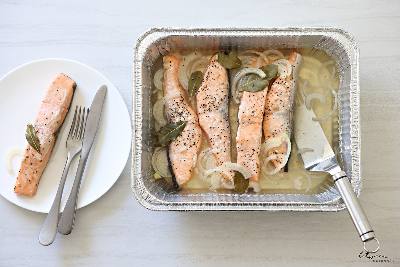 9 x 13 Sweet And Sour Salmon. One slice plated with a fork and knife.