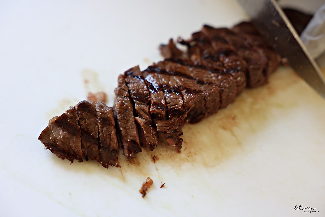 Slicing grilled strip steak.