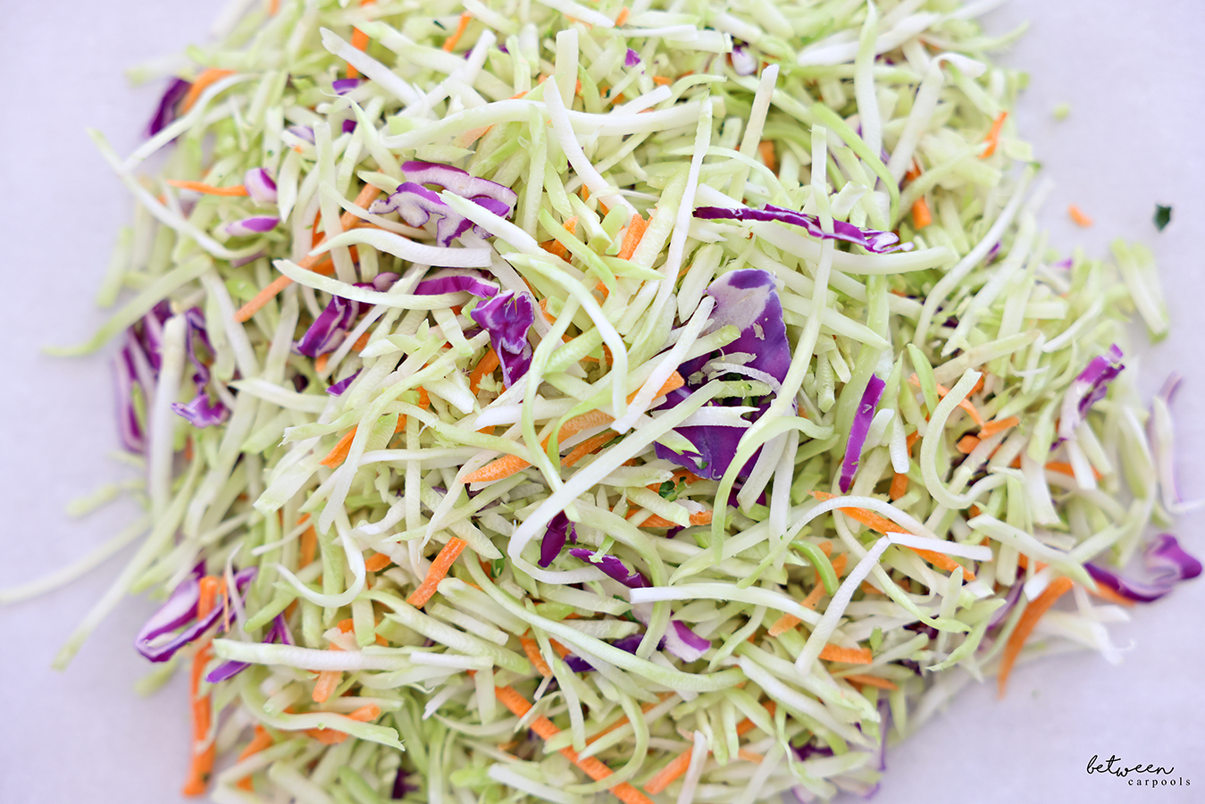 Broccoli slaw on a square of parchment paper.