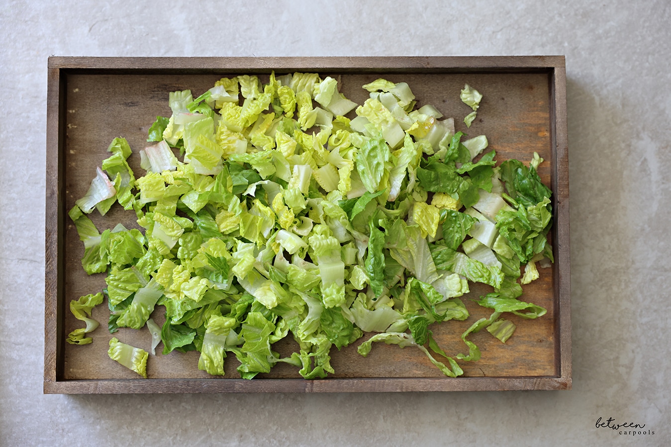 Romaine lettuce on a wooden board.