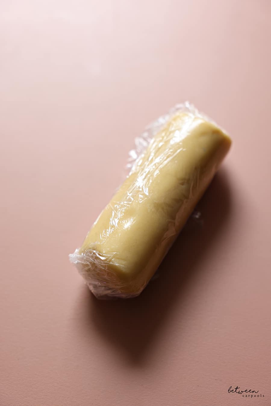 One log of French Butter Cookie dough wrapped in plastic wrap.