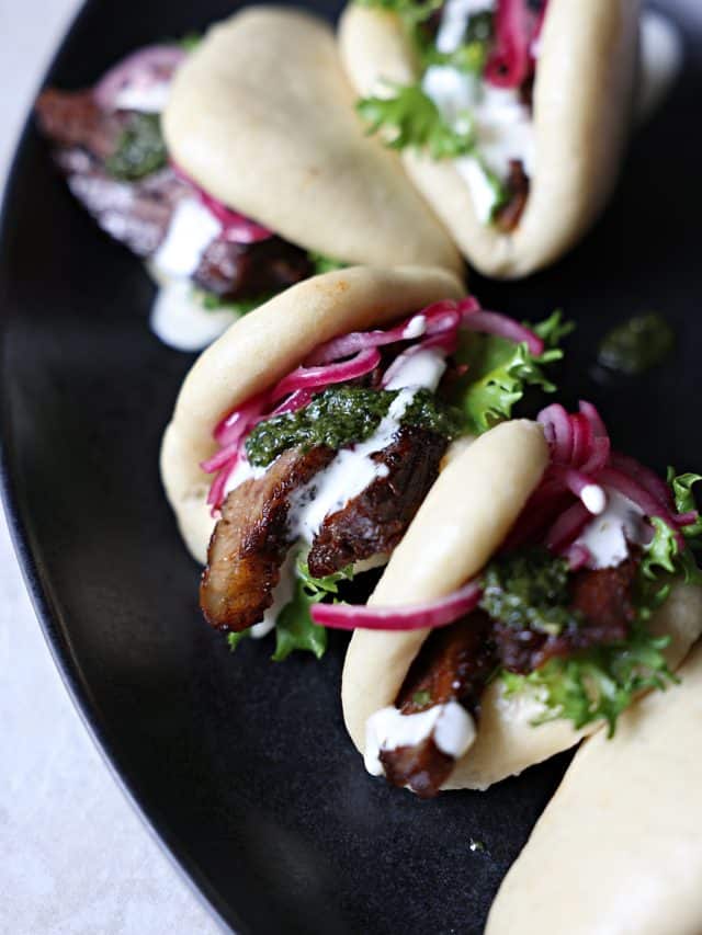 Bao Buns with Smoked Brisket, Pickled Onions, and Pesto