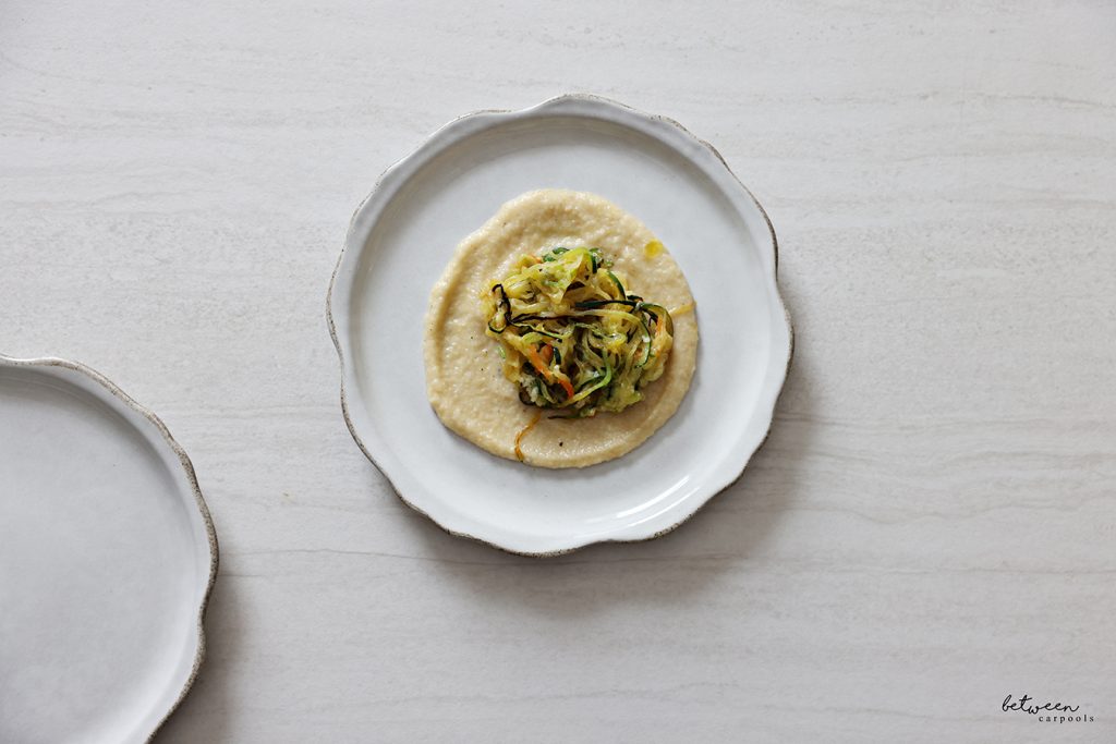 Plated zoodles over eggplant puree.