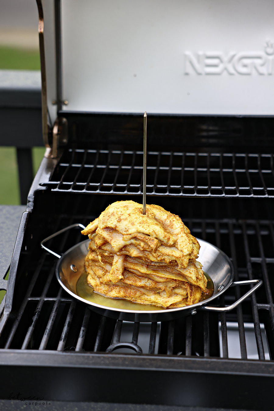 Layered cutlets on an Al Pastor Vertical Skewer on the grill.
