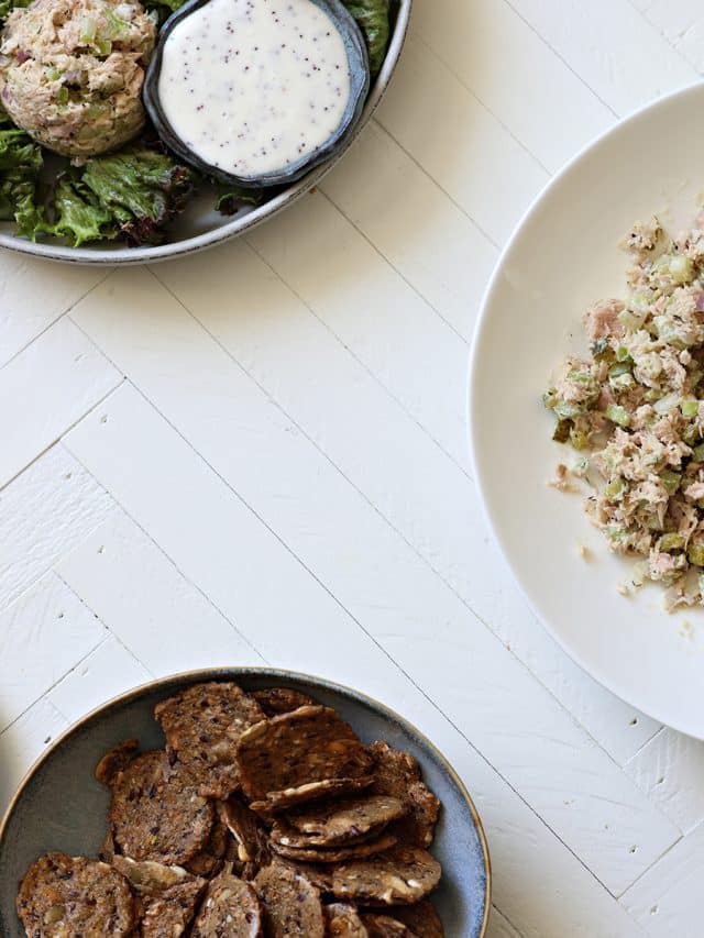 Upgraded Tuna Salad, a salad with a scoop of tuna and Mary's Gone Crackers in bowls.