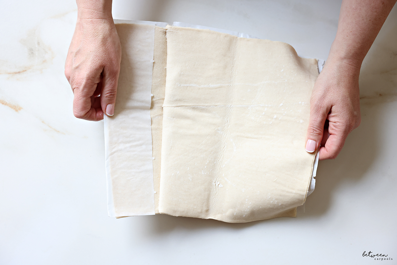 Opening a sheet of puff pastry.