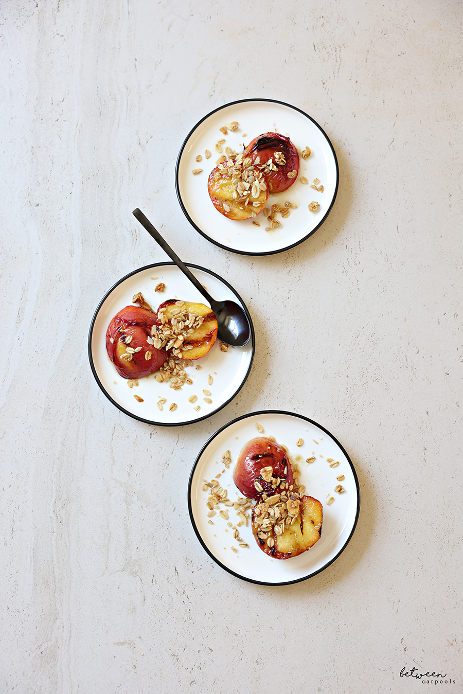Plated grilled peaches with bourbon glaze.